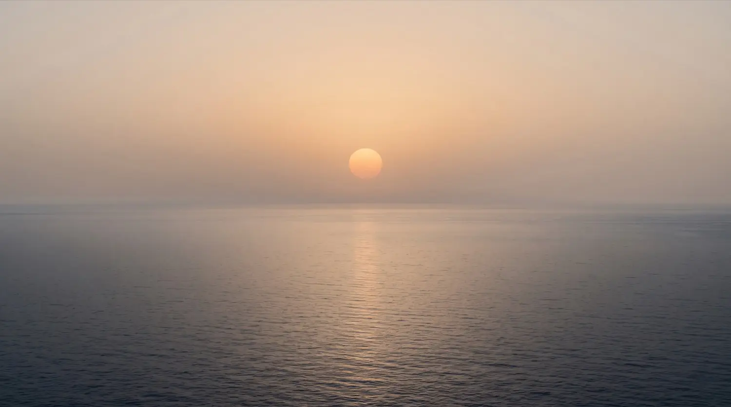 Sun low over open water seen from a vessel underway